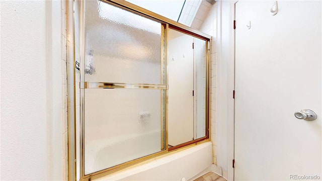 8701 Huron St Unit 1-207, Thornton, CO 80260 - bathroom featuring combined bath / shower with glass door