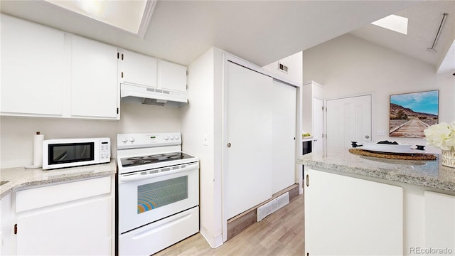 8701 Huron St Unit 1-207, Thornton, CO 80260 - kitchen featuring white appliances, under cabinet range hood, light wood finished floors, a skylight, and white cabinetry