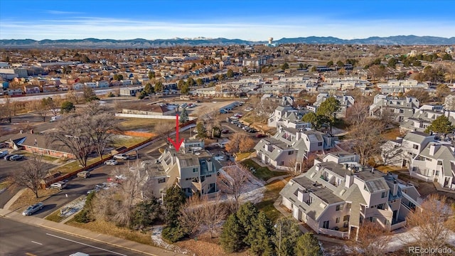 8701 Huron St Unit 1-207, Thornton, CO 80260 - aerial overview of property's location with nearby suburban area and a mountain backdrop