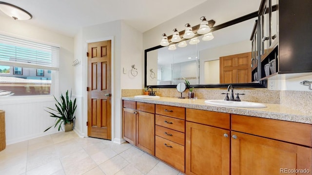 full bathroom featuring tile patterned flooring and double vanity