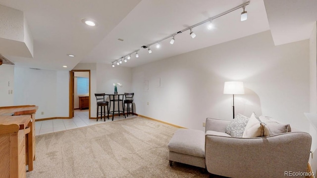 sitting room with carpet floors, recessed lighting, baseboards, tile patterned floors, and rail lighting