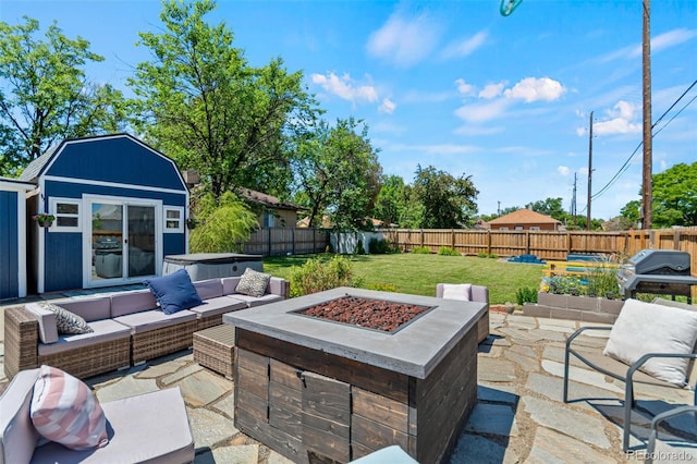 1390 Emporia St, Aurora, CO 80010 - fenced backyard featuring a patio area, area for grilling, an outdoor living space with a fire pit, and an outbuilding