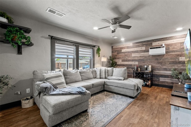 1390 Emporia St, Aurora, CO 80010 - living room featuring wooden walls, wood finished floors, ceiling fan, and recessed lighting