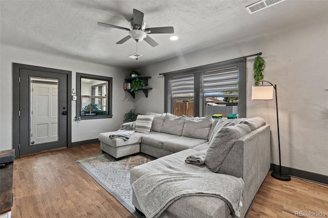 1390 Emporia St, Aurora, CO 80010 - living room featuring a ceiling fan, wood finished floors, and a textured ceiling