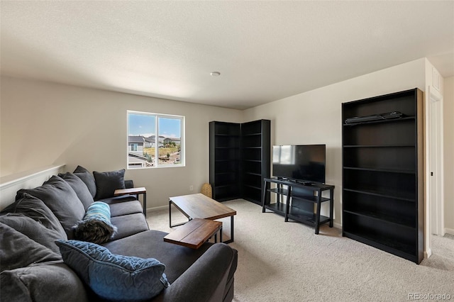 living room featuring light carpet and a textured ceiling