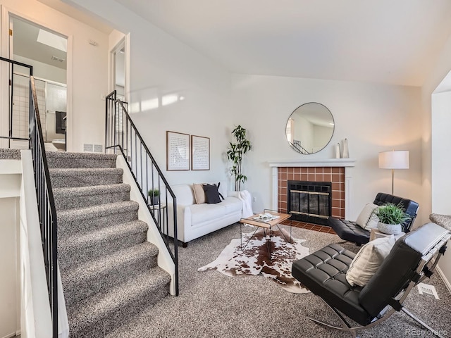 living room featuring carpet floors and a fireplace