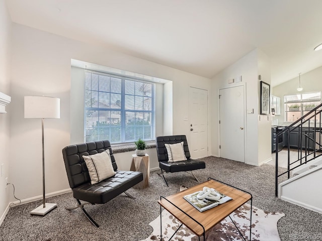 living room featuring carpet floors and vaulted ceiling