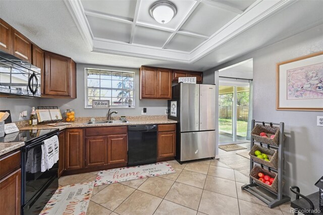 kitchen with a wealth of natural light, a sink, black appliances, and coffered ceiling
