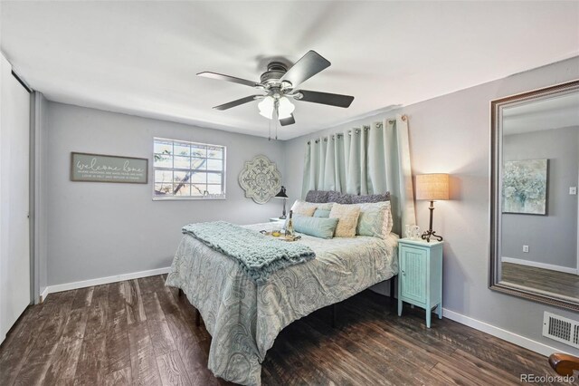 bedroom with baseboards, ceiling fan, dark wood-type flooring, and visible vents