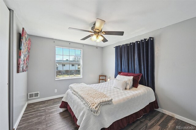 bedroom with visible vents, a ceiling fan, baseboards, and dark wood-style floors