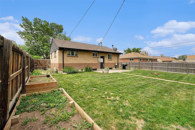 7625 Turner Dr, Denver, CO 80221 - rear view of property with a vegetable garden, brick siding, a patio, and a fenced backyard