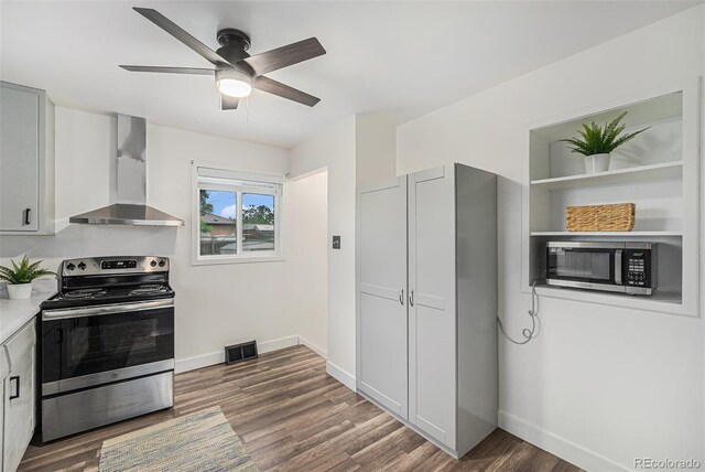 7625 Turner Dr, Denver, CO 80221 - kitchen featuring wall chimney exhaust hood, appliances with stainless steel finishes, a ceiling fan, wood finished floors, and light countertops