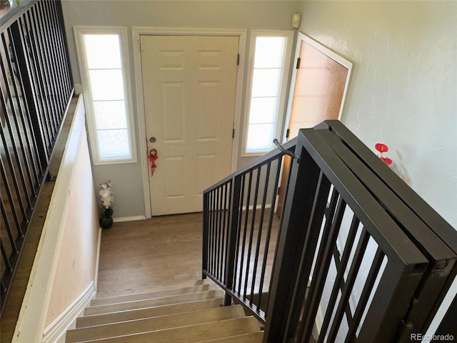 staircase featuring a wealth of natural light and hardwood / wood-style floors