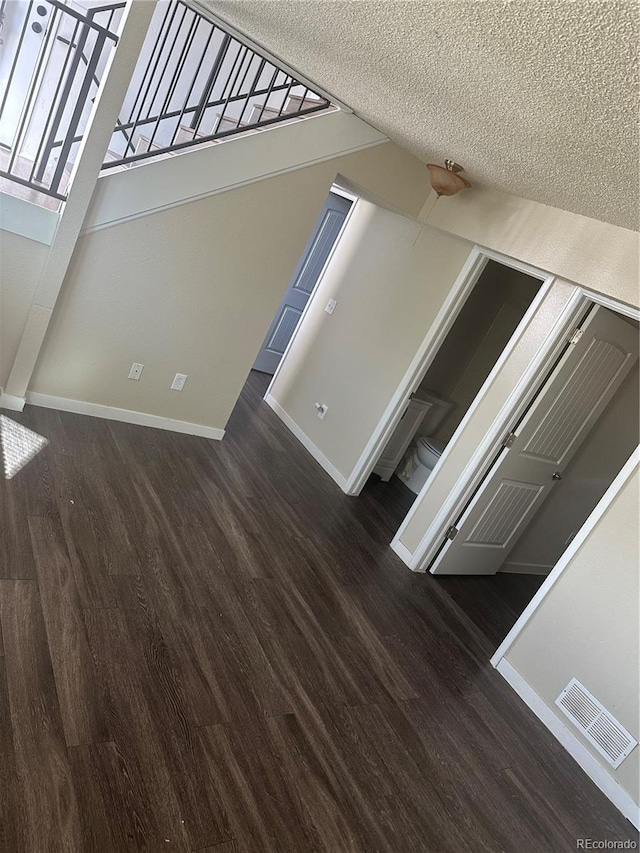 interior space featuring dark hardwood / wood-style flooring and a textured ceiling