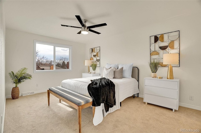 bedroom with light carpet, visible vents, ceiling fan, and baseboards