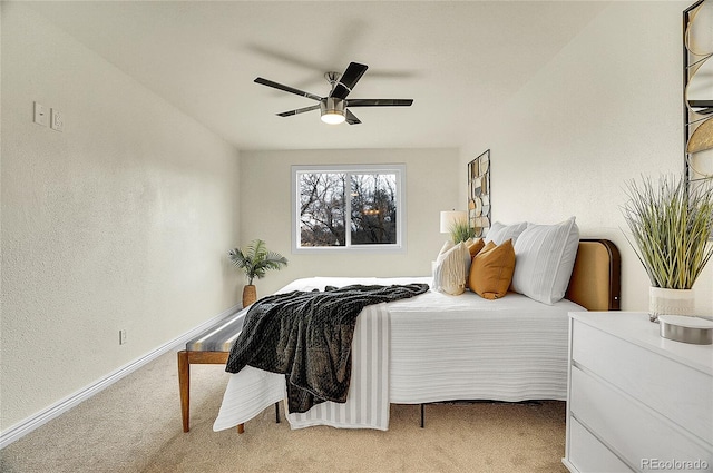 bedroom with a ceiling fan, light colored carpet, and baseboards