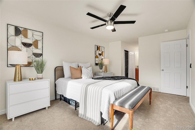 carpeted bedroom featuring connected bathroom, baseboards, and a ceiling fan