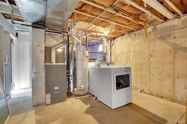 unfinished below grade area featuring heating unit, washing machine and dryer, and water heater