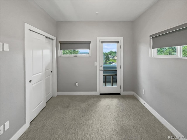 1245 Utica St Unit 104, Denver, CO 80204 - entryway featuring healthy amount of natural light and carpet floors