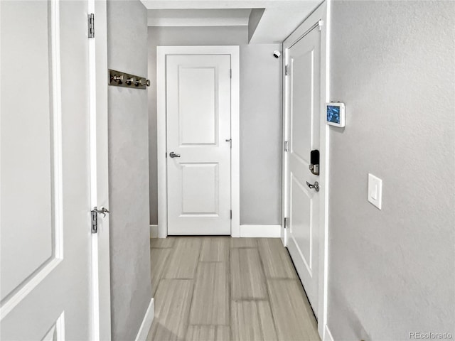 1245 Utica St Unit 104, Denver, CO 80204 - hall featuring baseboards and light wood finished floors