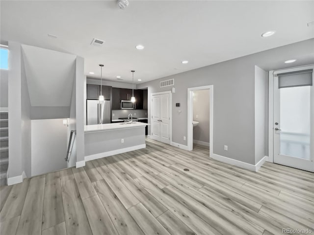 1245 Utica St Unit 104, Denver, CO 80204 - unfurnished living room featuring recessed lighting and light wood finished floors