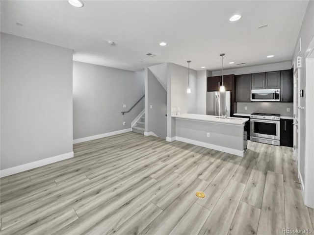 1245 Utica St Unit 104, Denver, CO 80204 - unfurnished living room with recessed lighting, light wood-style floors, and stairs