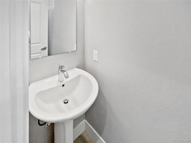 1245 Utica St Unit 104, Denver, CO 80204 - bathroom with a sink and a textured wall