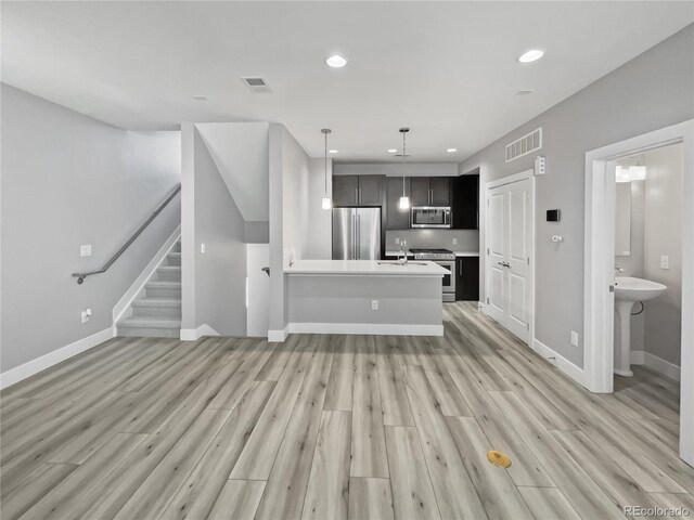 1245 Utica St Unit 104, Denver, CO 80204 - unfurnished living room featuring light wood-style flooring, recessed lighting, and stairs