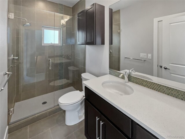 1245 Utica St Unit 104, Denver, CO 80204 - bathroom featuring vanity, a stall shower, and tile patterned flooring