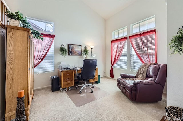 carpeted office space with high vaulted ceiling