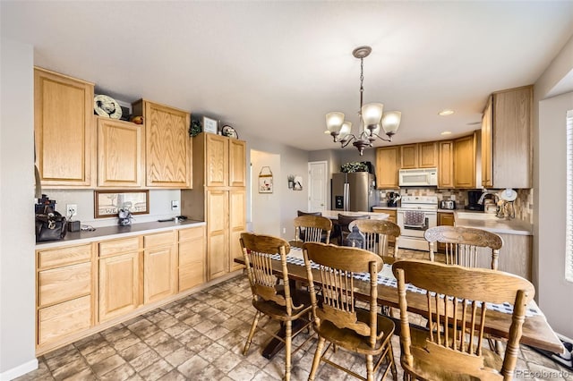 dining area with a notable chandelier and sink