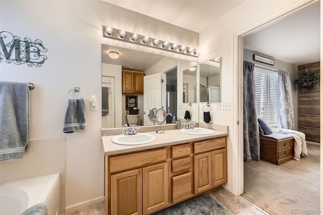 bathroom with vanity and a tub