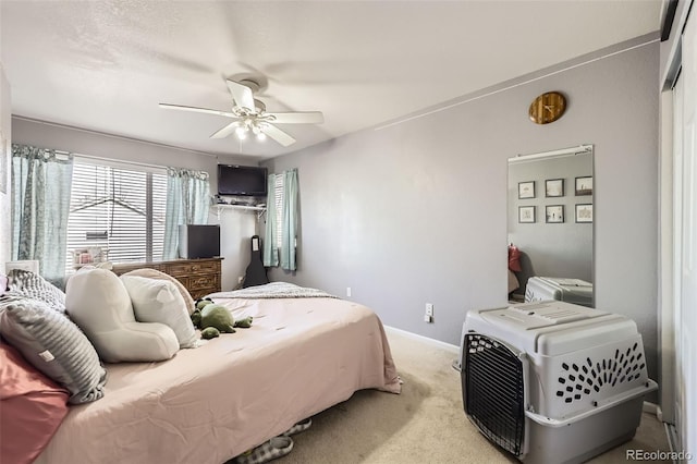 bedroom featuring ceiling fan and light carpet