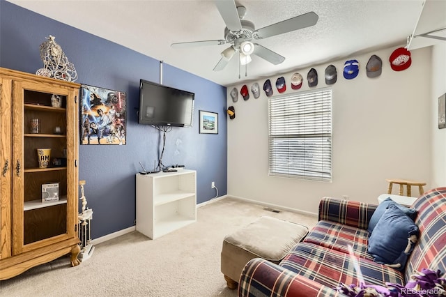 carpeted living room with ceiling fan