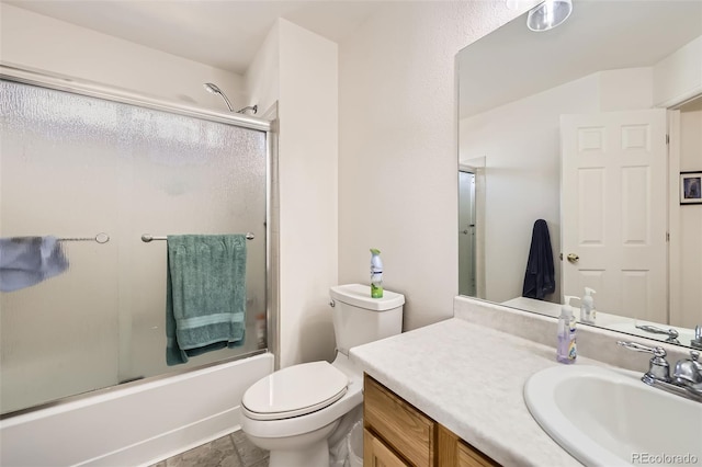 full bathroom featuring combined bath / shower with glass door, vanity, and toilet