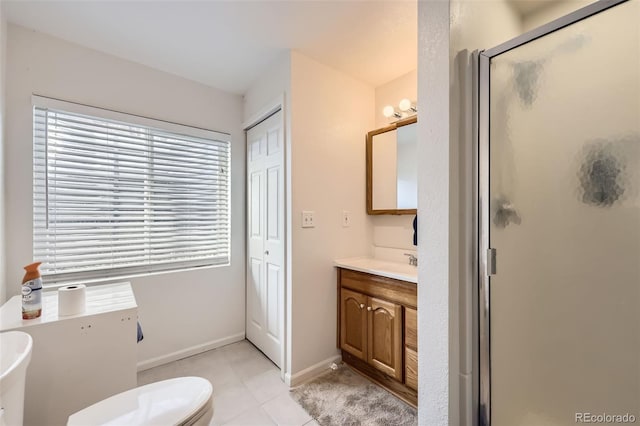 bathroom featuring tile patterned flooring, vanity, an enclosed shower, and toilet