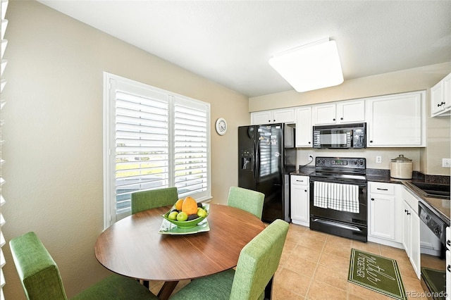 2567 Cutters Cir Unit 101, Castle Rock, CO 80108 - kitchen featuring black appliances, dark countertops, white cabinetry, and light tile patterned floors