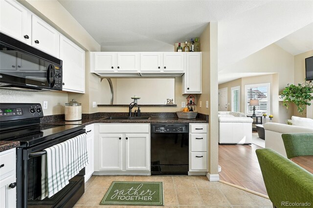 2567 Cutters Cir Unit 101, Castle Rock, CO 80108 - kitchen featuring black appliances, white cabinetry, open floor plan, and vaulted ceiling