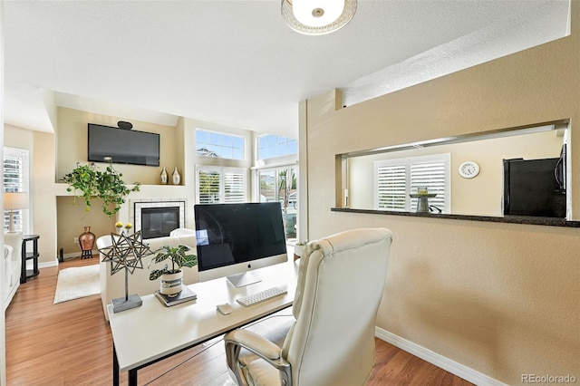 2567 Cutters Cir Unit 101, Castle Rock, CO 80108 - office area with wood finished floors and a glass covered fireplace