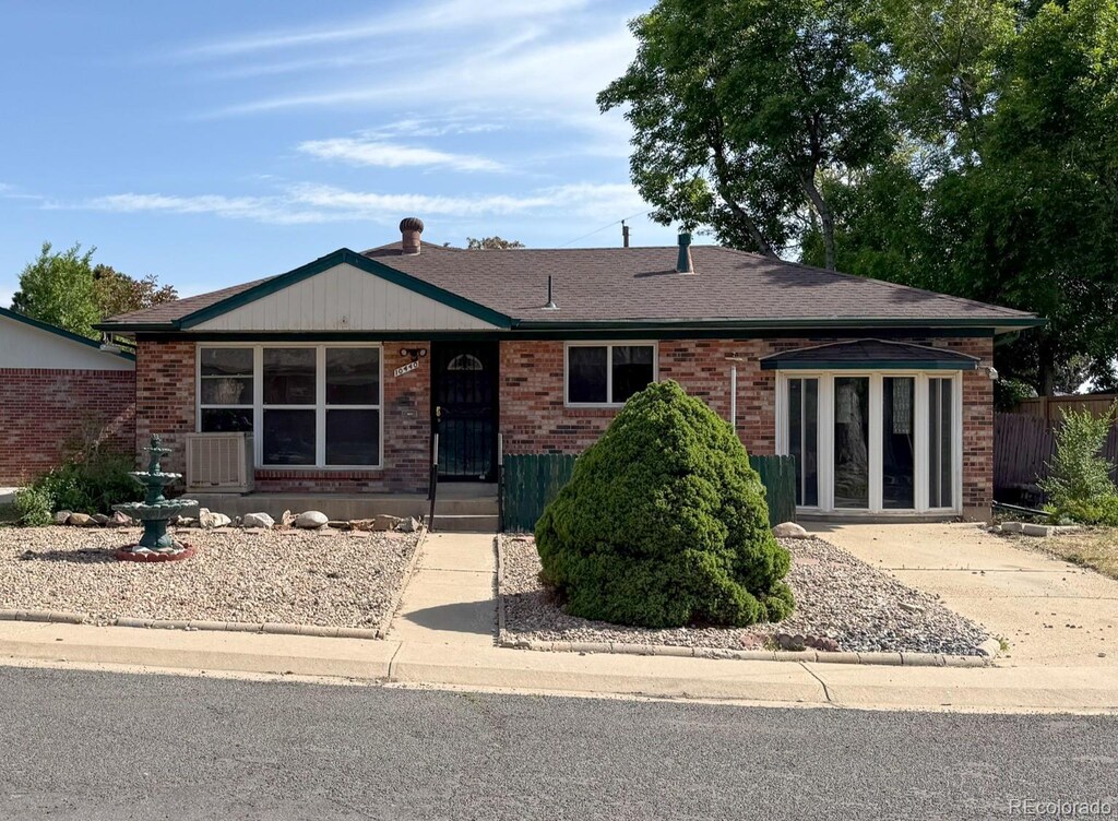 10440 Gilpin St, Northglenn, CO 80233 - view of front of home with brick siding and roof with shingles