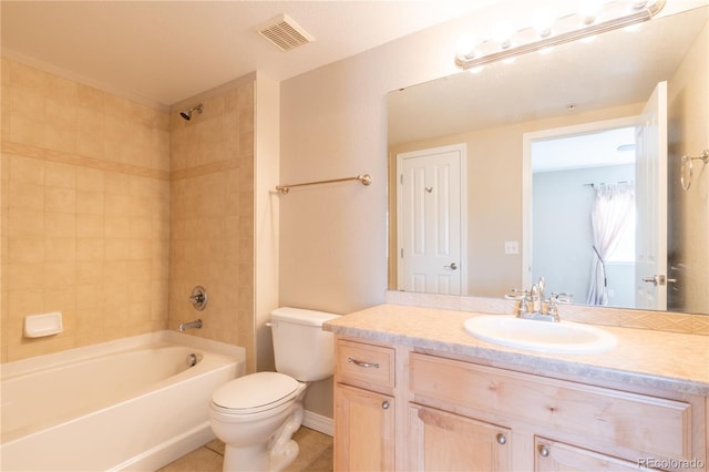 full bathroom featuring toilet, tiled shower / bath combo, vanity, and tile patterned flooring