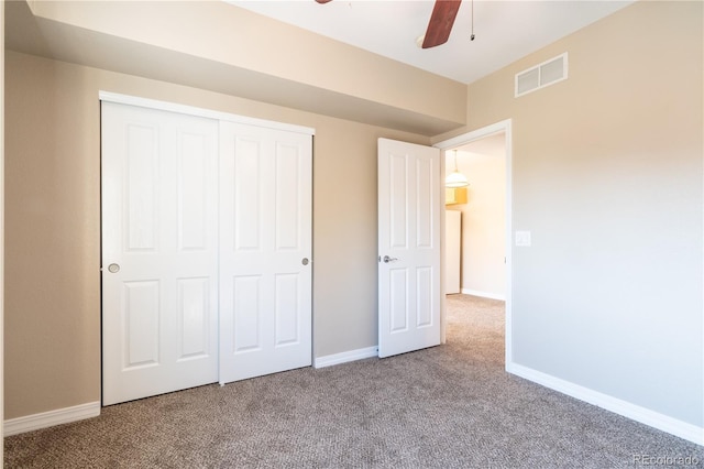 unfurnished bedroom with visible vents, a ceiling fan, a closet, baseboards, and carpet flooring