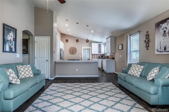 123 Blue Stem St, Brighton, CO 80601 - living room featuring vaulted ceiling, dark wood-style flooring, ceiling fan, arched walkways, and recessed lighting