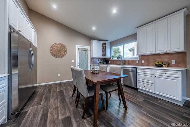 123 Blue Stem St, Brighton, CO 80601 - dining area featuring dark wood-type flooring, vaulted ceiling, and recessed lighting