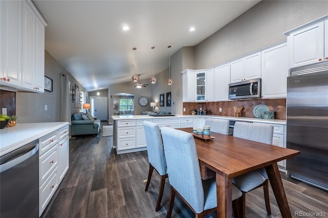 123 Blue Stem St, Brighton, CO 80601 - kitchen with appliances with stainless steel finishes, a peninsula, lofted ceiling, open floor plan, and tasteful backsplash