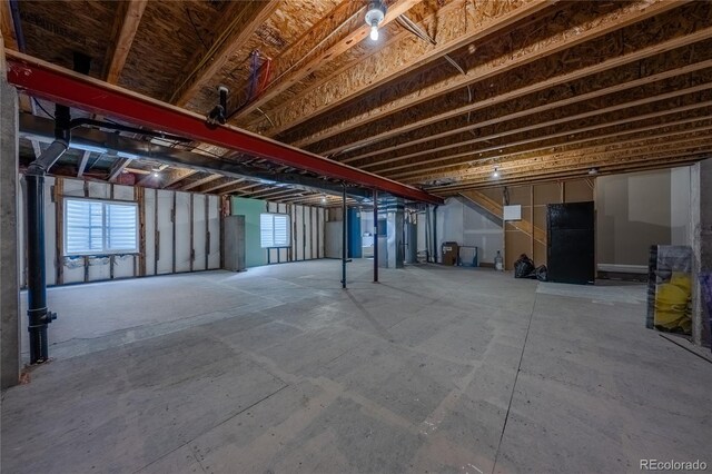 123 Blue Stem St, Brighton, CO 80601 - basement with freestanding refrigerator and plenty of natural light