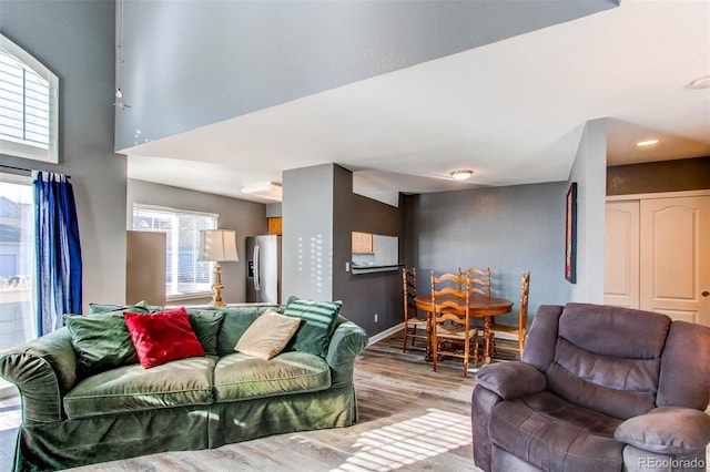 living room featuring wood finished floors and baseboards