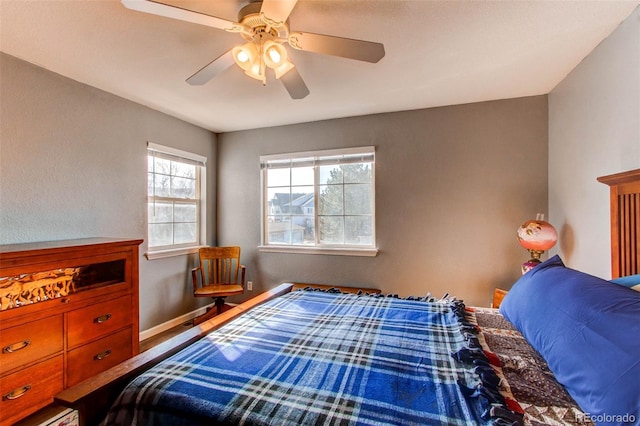 bedroom featuring a ceiling fan and baseboards