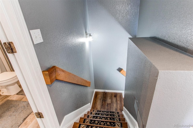 stairs featuring baseboards and wood finished floors