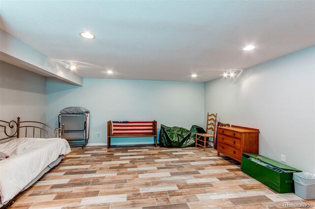 bedroom featuring wood finished floors and recessed lighting